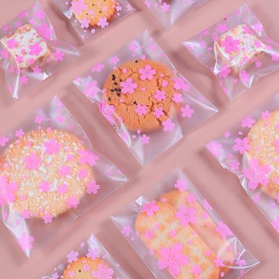 China 100pcs Clear Recyclable Self Adhesive Plastic Bag Cherry Blossoms Snack Candy Bag for sale