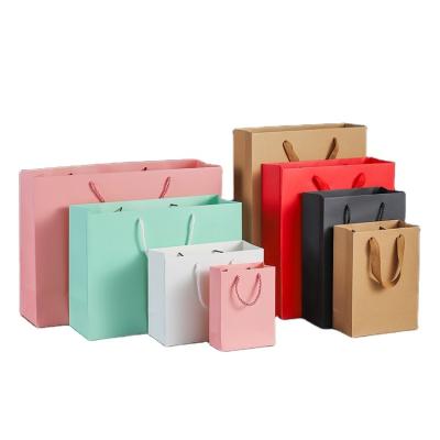 China Recycled Materials Hot Selling In China Clothing Store Packaging Kraft Paper Bag Paper Gift Shopping Bags for sale