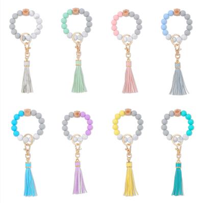 China Customized Environmental Friendly Silicone Bead Bracelet Key Chain PU Tassel Leather Bag Pendant Accessory for sale