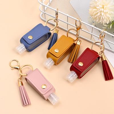 China 2021 Environmentally Friendly New Arrive PU Tassel Leather Bag Key Chain For Women Men Hand Sanitizer Bottle Cute Wavy PU Leather Hand Key Chain Purse Bag for sale