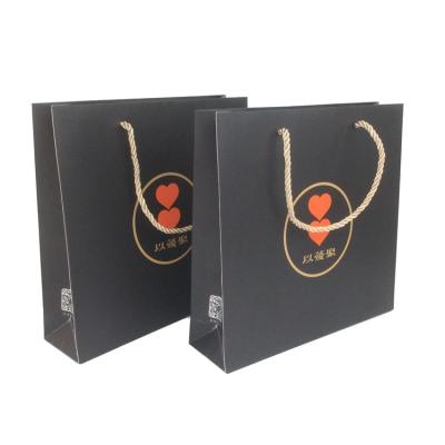 China Matt Lamination Black Luxury Folding Recyclable Gift Packaging Paper Bags for sale