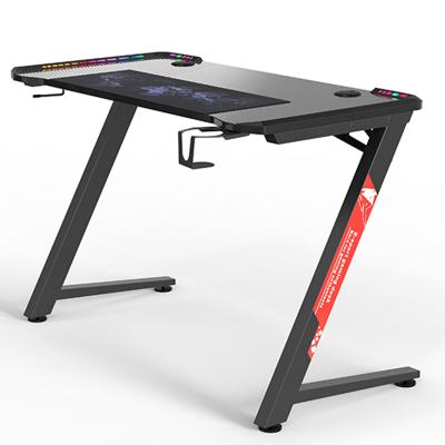 China New Convertible Professional Ergonomic Gaming Desk With RGB LED Light E-sports Computer Table Stand Desk Laptop Desk With Cup Holder for sale