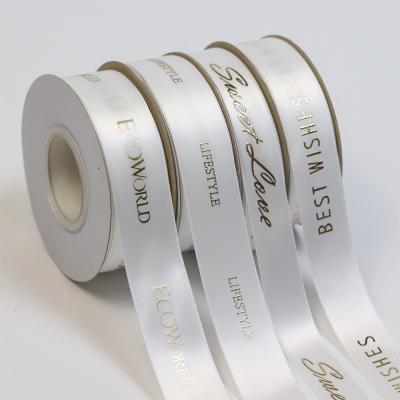 China Luster China lude own brand printed raised white gold foil printing satin ribbon with logo for sale