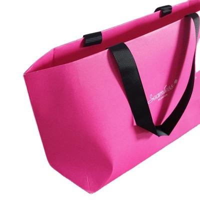 China Customized Recycled Paper Logo Printing Recycle Material Craft Paper Shopping Bag Ribbed Handle Ribbon Pink Color Printed Shoes Packaging Bag for sale