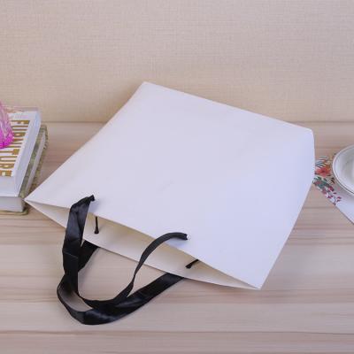 China Recyclable Customized White Paper Art Paper Shopping Bag With Rope Handle for sale