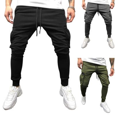 China Anti-wrinkle solid color stacked jogger pants with side pockets fashionable cargo pocket zipper style men pants drawstring pocket pants men for sale