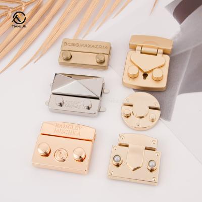 China Eco-friendly Logo Metal Bag Clasps And Custom Closure Zinc Alloy Material For Handbag Push Turn Twist Lock Bag Lock for sale