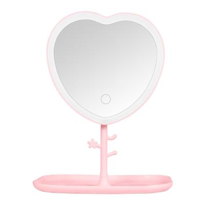 China Personalized Heart Shaped LED Touch Screen Makeup Mirror With Storage Shelf HD Dorm Mirror Girly Desktop Portable Mirror With Light for sale