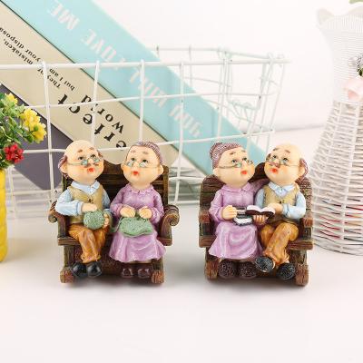 China China creative resin home crafts cartoon leisure rocking chair couple resin decoration elderly bedroom home decoration for sale