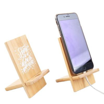 China China Customized Logo Hollow Pattern Wooden Bamboo Cell Phone Holder Smart Phone Holder With Chargeable Hole For Home And Office for sale