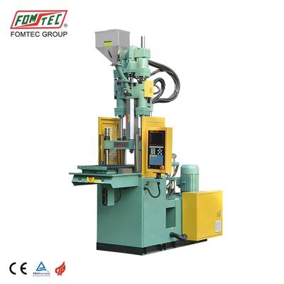 China FOMTEC 400 kN VERTICAL single vertical sliding table injection molding machine casting machine price lists phone case machine for sale