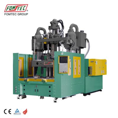 China FOMTEC 2200 kN VERTICAL machine vertical molding machine rotary table large auto parts injection inyection clamping machine for sale