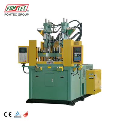 China FOMTEC VERTICAL 1600 kN rotary table multi color vertical injection molding machine led module injection machine for sale