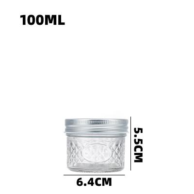 中国 Embossed Clear Glass Storage Jar With Screw Cap For Coffee Bean Peanut Oatmeal 販売のため