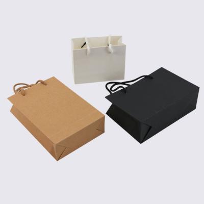 China Eco - Friendly Recycled Materials OEM / ODM Paper Packaging Bags For Clothing Custom Logo Paper Package Bags With Handle for sale