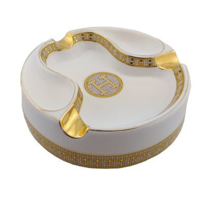 China Fasion Best Selling Nice Design Unique Round Custom Ceramic Cigar Ashtray With Custom Logo With Golden Rest for sale