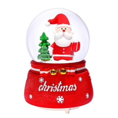 China Europe 80mm 100mm Christmas rotating snow globe with music and lighting for wholesale for sale