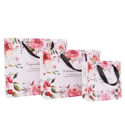 China 2022 new design china suppliers recyclable custom printed flower gift mailing bag, foldable paper shopping bag for t-shirt for sale