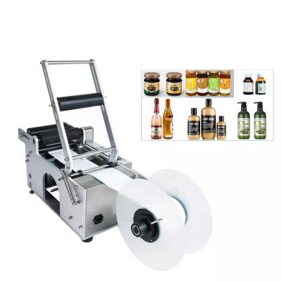 China Manual Sticker Printer Low Price Oil Food CBD Labeling Machine For Round Bottles for sale