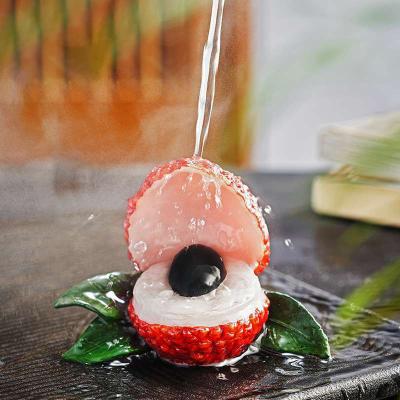 China New Style China Tea Table Decoration Toy Hot Water Discolor Litchi Ornament Orange Color Changing Resin Crafts for sale