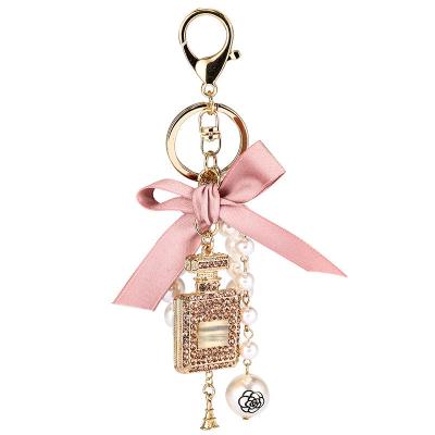 China Wholesale CLASSIC Diamond Perfume Bottle Metal Key Chains Bow-knot Pearl Pendant Key Chain Accessories For Women Men for sale