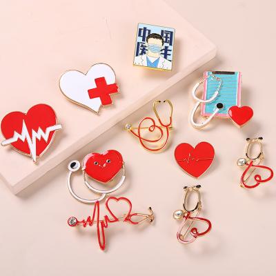 China ALLOY Wholesale Fashion Gifts Brooch Medical Enamel Pin Doctor Nurse Accessories Brooch Pin Stethoscope Electrocardiogram Heart Shaped for sale