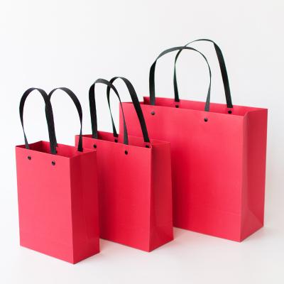 China Custom Eco Friendly Hot Selling Recyclable Paper Bag Packaging Rivet Red Paper Bag for sale