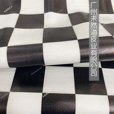 China Wrinkle Resistant 4.6cm Black And White Sheepskin Plaid Top Layer Leather Digital Printing Genuine Leather for sale