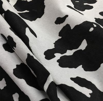 China Wrinkle Resistant Black And White Cows Printed Cow Fur Factory Direct Sales Genuine Leather for sale