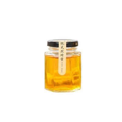 China 100ml Honey Stored Jars Hexagon Shaped Small Glass Jar Honey Food Storage Jar With Lids for sale