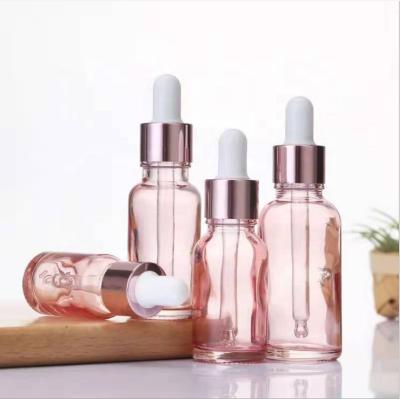 China Customized Light Pink Essential Oil Cosmetic Glass 30ml Dropper Bottle For Essential Oil With Rose Gold Ring Dropper Cap for sale