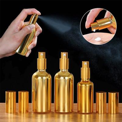 China Essential Oil 30ml 50ml 100ml Plated Gold Glass Bottle Essential Oil Spray Bottle With Gold Cap Child Safe Gold PUMP SPRAYER for sale