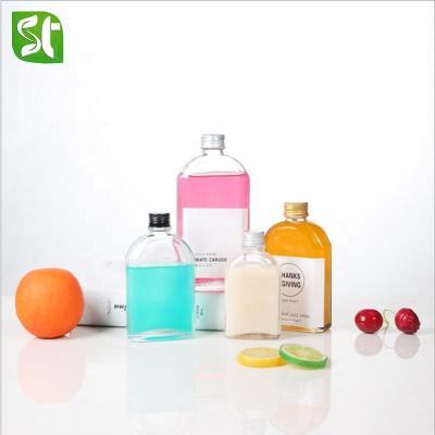 China Stocked New Fruit Milk Wine Tea Bottle Flat Glass Bottle With Aluminum Cover for sale