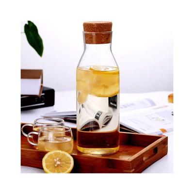 China Sustainable Wholesale Reasonable Price Storage Glass Water Bottle With Wooden Lid for sale