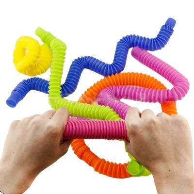 China Hot Selling Rainbow Color Children's Toys Stretched Top Moveable Person Toy Noise Tube Magic Tube for sale