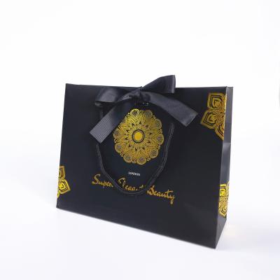 China Paper Bag Manufacturers Wholesale Disposable Custom Gold Foil Gift Paper Bags Deembossed Paper Bag for sale