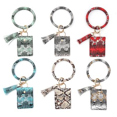 China Waterproof Amazon Top Selling Women Wristlet Wallets Key Chain ID Card Holder Key Ring Tassel Snake Skin Leather Wristlet Wallet for sale