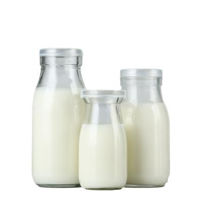 China Food Customized 250ml 500ml Clear Round Empty Glass Milk Bottle With Tin Cap for sale