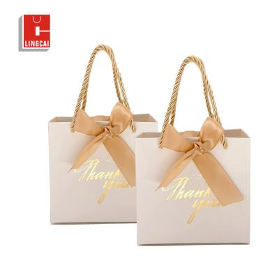 China Recyclable Custom Logo Pink White Kraft Gift Craft Shopping Paper Bag With Ribbon Handle For Christmas for sale