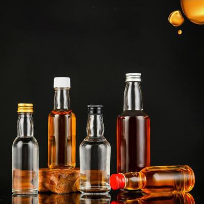 China 30ml 40ml 50ml 100ml Mini Small Sample Alcohol Juice Drinks Glass Wine Liquor Bottle with Screw Cap for sale