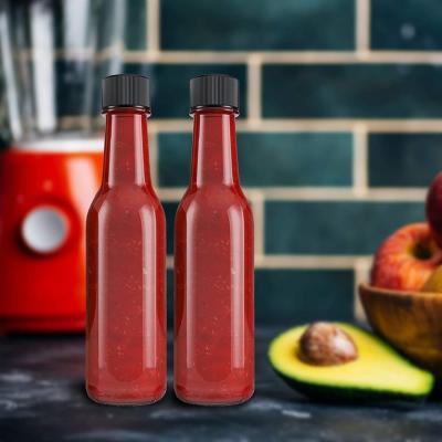 China 5oz 150ml Clear Empty Soy Sauce Glass Bottle Woozy Bottle With Clip Cap for Hot Sauce à venda