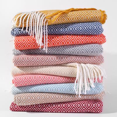 China Popular Wholesale Promotional Solid Color Fleece Jacquard Soft Woolly Tassel Woven Folded Travel Blankets for sale