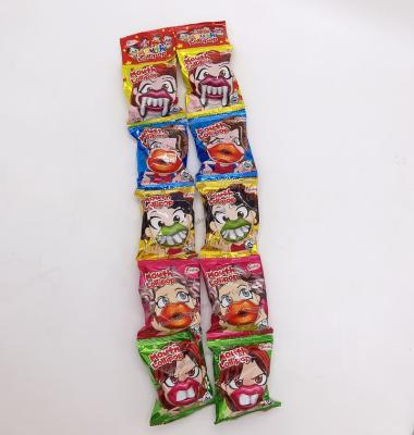 China Glucose Funy Cotton Mouth Form Teeth To Fruit Flavor Hard Toy Candy With Sweet Fruit Lollipop for sale