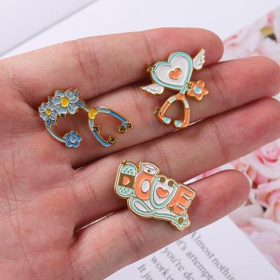 China ALLOY European and American Hot Selling Stethoscope Brooches Love Wings Flower Medical Equipment Brooch Badge Clothing Accessories Pin for sale