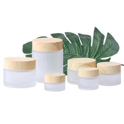 China Recyclable cheap price 5g 10g 15g 30g 50g 100g empty gel glass jar with plastic bamboo cap for sale