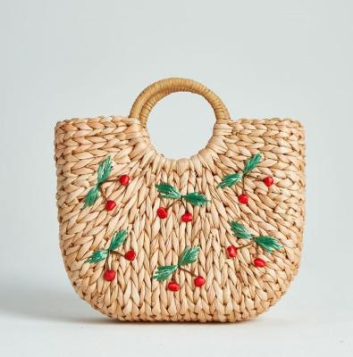 China 100% new custom wholesale cheap moon woven straw beach bag cherry embroideries design eco-friendly corn husk corn husk hallf embroidery for sale