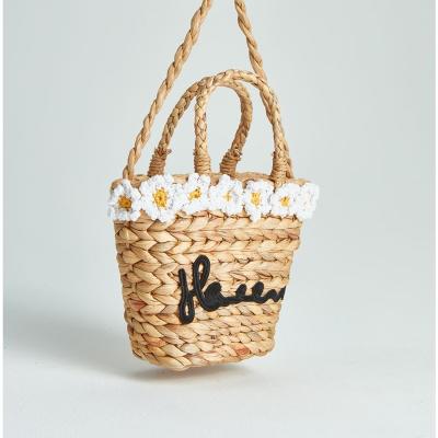 China Cheap 100% Waters Eco-friendly Flower Lace Decoration Hyacinth Grass 100% Straw Bali Beach Bag Natural for sale