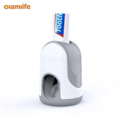 China OLAMLIFE Toothpaste Hands Toothbrush Holder Family Wall Mounted Plastic Viable Toilet Room Automatic Toothpaste Dispenser for sale