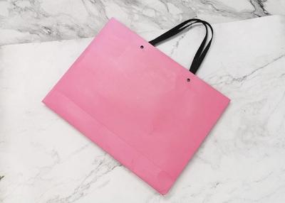 China Pink Colored Matt Pattern Kraft Paper Carrier Bags Recyclable With Black PP Handle for sale