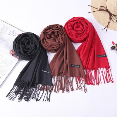 China Custom logo 200*70cm soft soft feeling winter shawls pashmina polyester cashmere scarf with tassel for sale